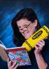 Picture of Molly Babcock holding a large yellow crayon