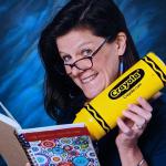Picture of Molly Babcock holding a large yellow crayon